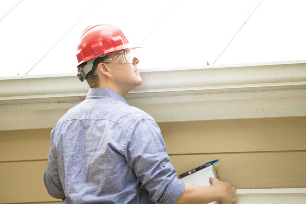 United Bat Control technician sealing bat entry points on a rooftop